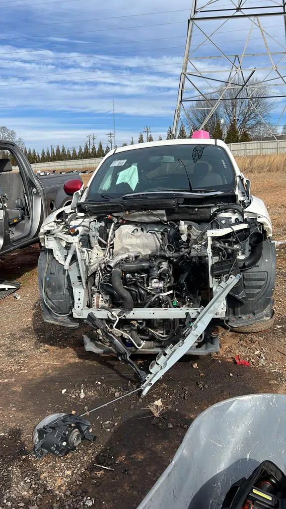 Car with front end disassembled and engine exposed outdoors — PIQUET AUTO SERVICE in Greenville
