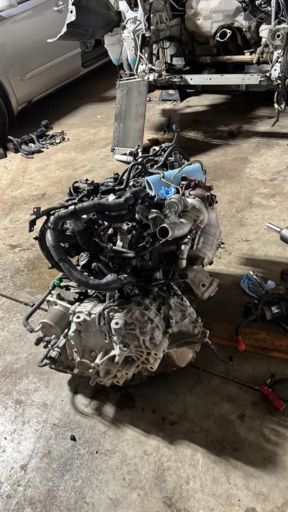Engine and transmission removed from a vehicle in the shop — PIQUET AUTO SERVICE in Greenville